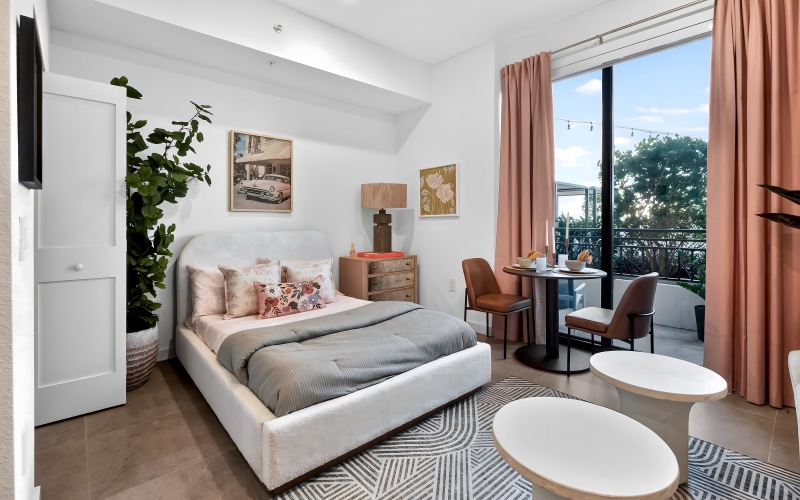 Modern studio layout with floor-to-ceiling windows and a private balcony at The Holly at Soleste apartments in Hollywood, FL