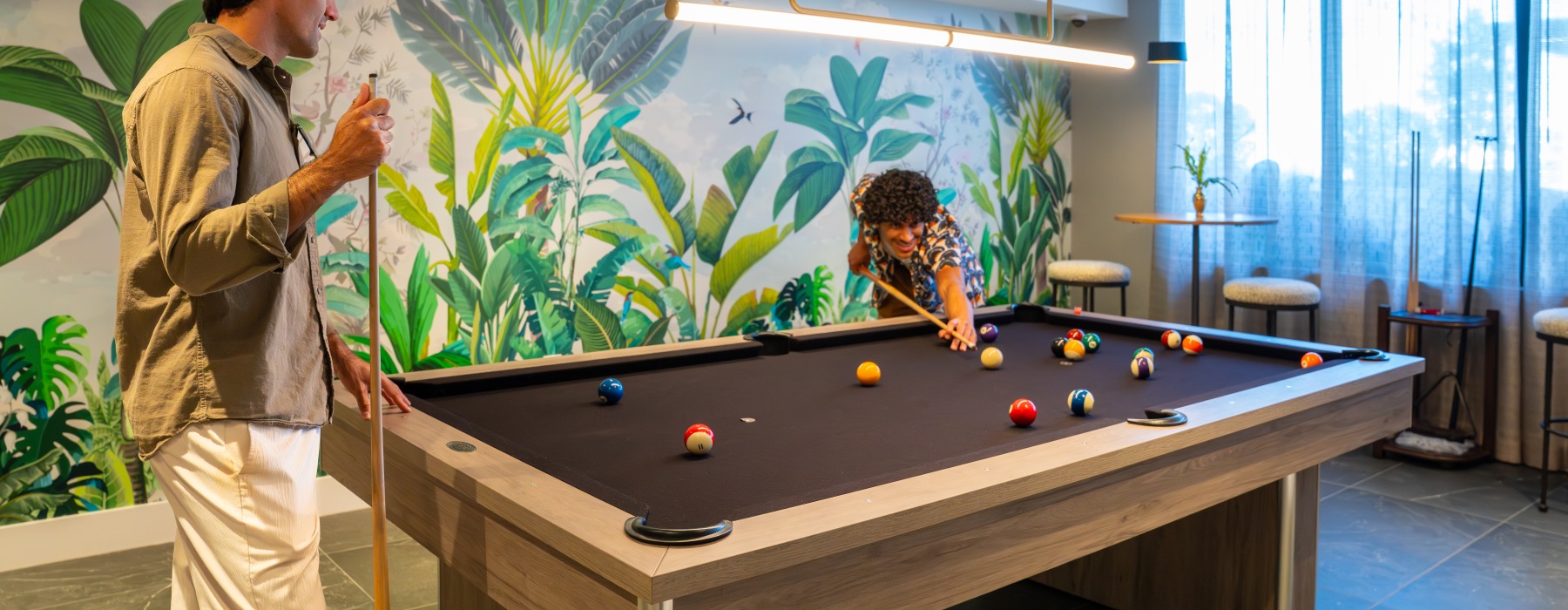 Modern resident game room with billiards table at The Holly at Soleste luxury apartments in Hollywood, Florida featuring upscale amenities and entertainment spaces near Hollywood Beach.