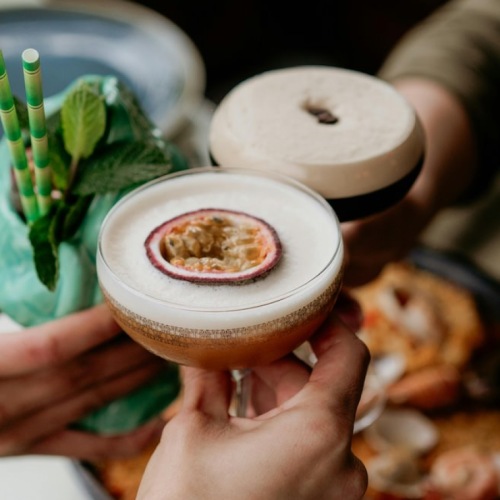 a group of people having a toast in a restaurant