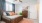 a bedroom with a bed and a fan